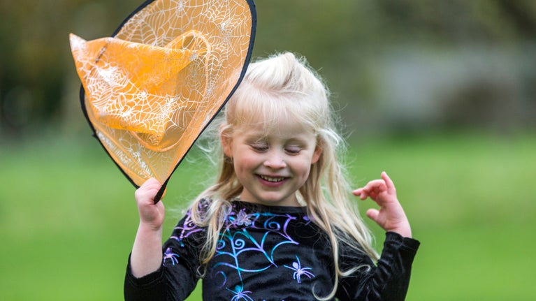 Girl wearing a witch costume for Halloween at Nunnington Hall, North Yorkshire.